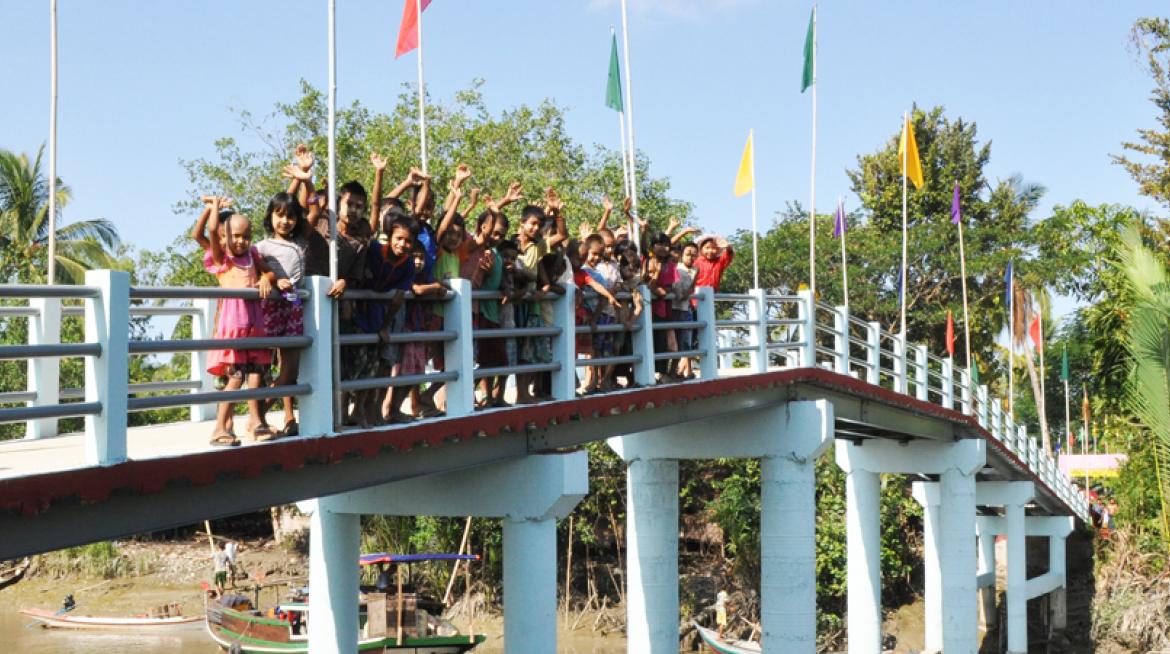 Fear of the storm is left behind, Kun Thee Chaung villagers waving their hands at the ceremony of the bridge launch Fear of the storm is left behind, Kun Thee Chaung villagers waving their hands at the ceremony of the bridge launch